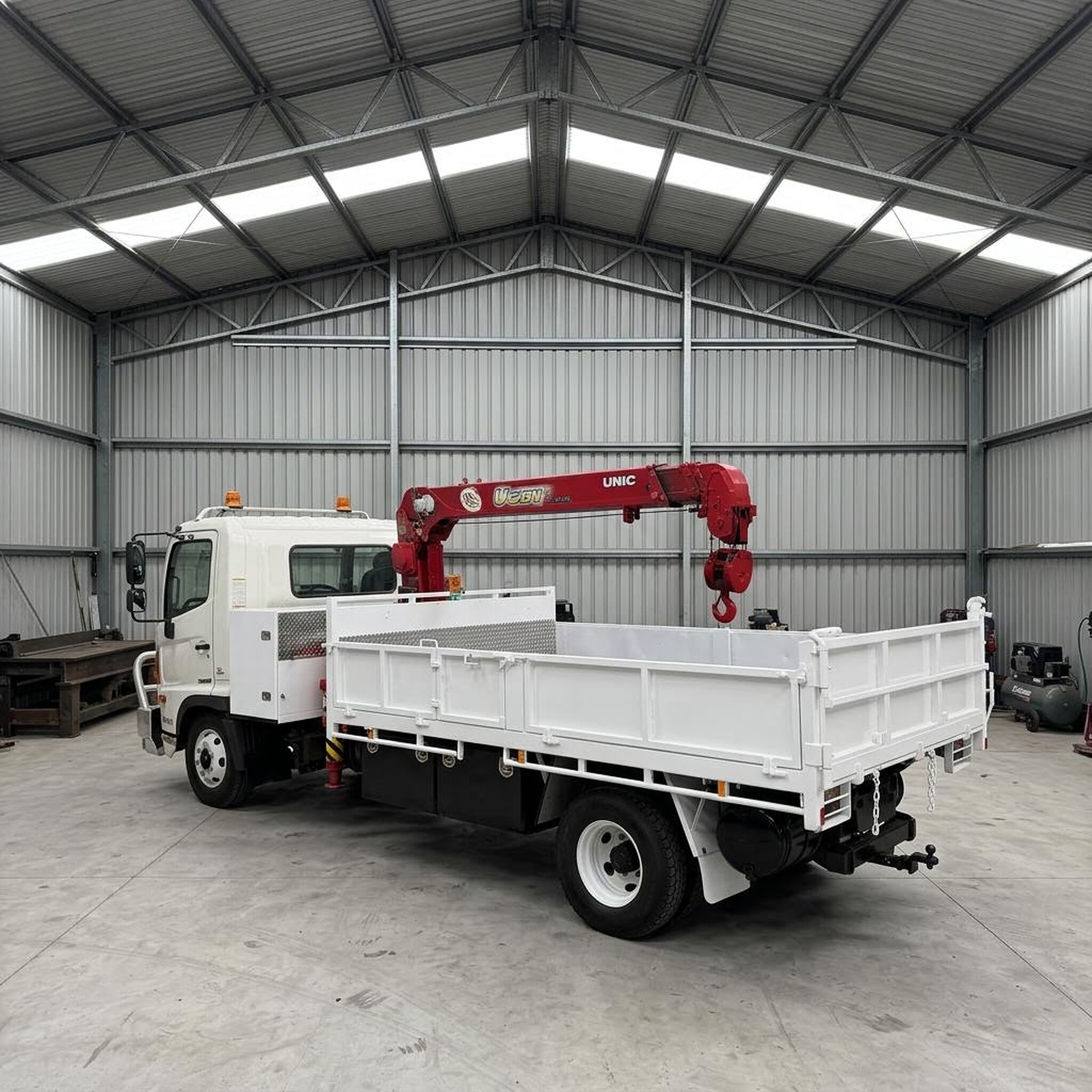 Hino FC 500 UNIC crane tipper rear view and tipper body